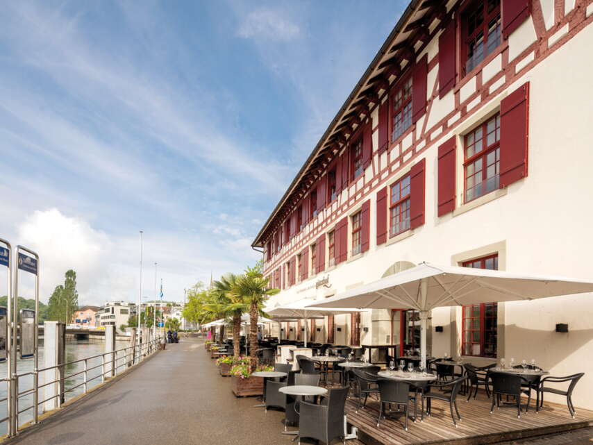 Terrasse des Restaurant Güterhof mit einer holzigen Terrasse direkt am Rhein.